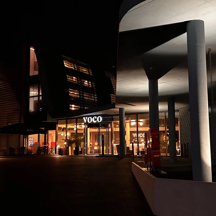 The entrance of a hotel lit up at night