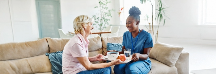 Care assitant serving elderly in a care home