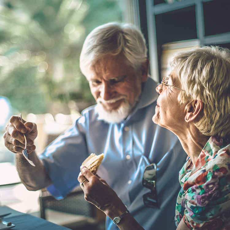 Elderly couple enjoying food together