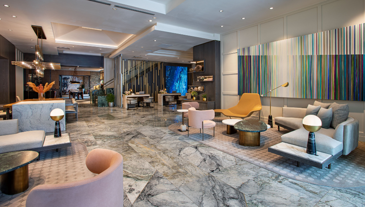 A modern hotel lobby with elegant marble flooring and stylish seating areas.