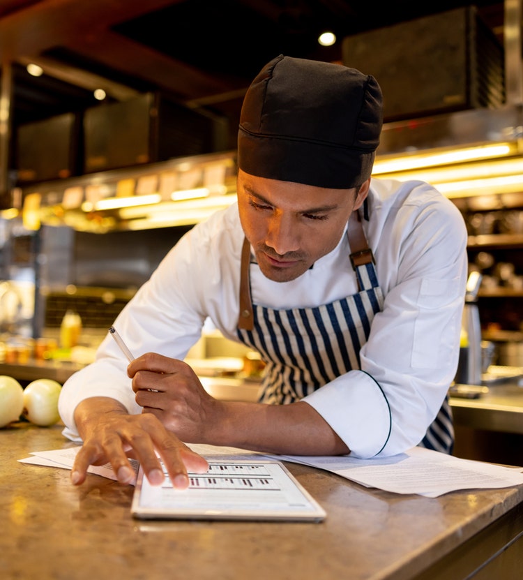 Chef analyzing data visualizations