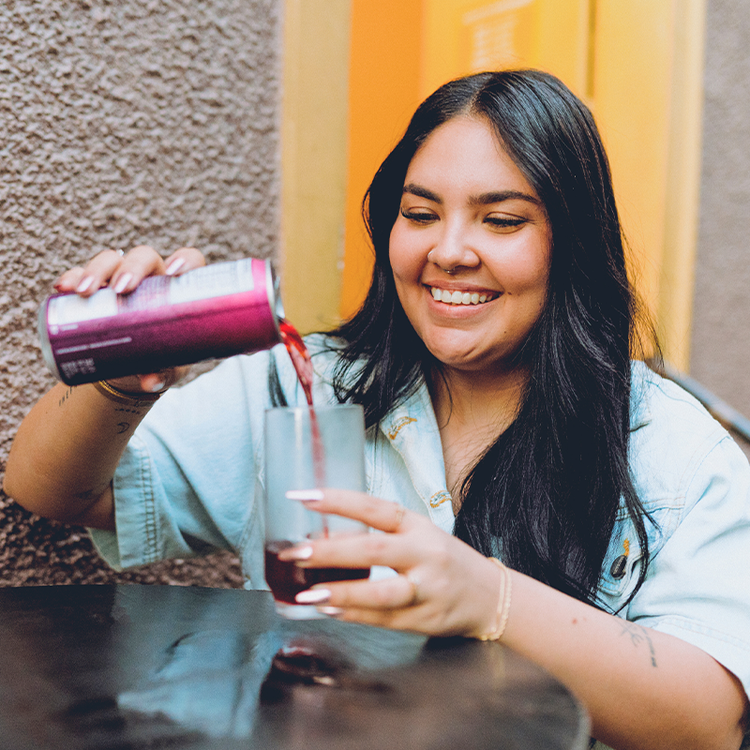 Customer pouring a canned soft drink as part of a convenient grab-and-go food experience