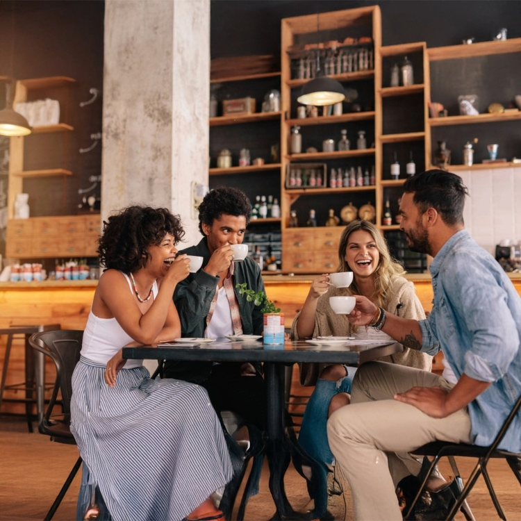 group of friends in a coffee shop drinking coffee