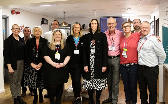 Large group of people smiling and posing for a photo
