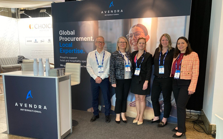 Large group of people from Avendra smiling and posing for a photo in a network event.