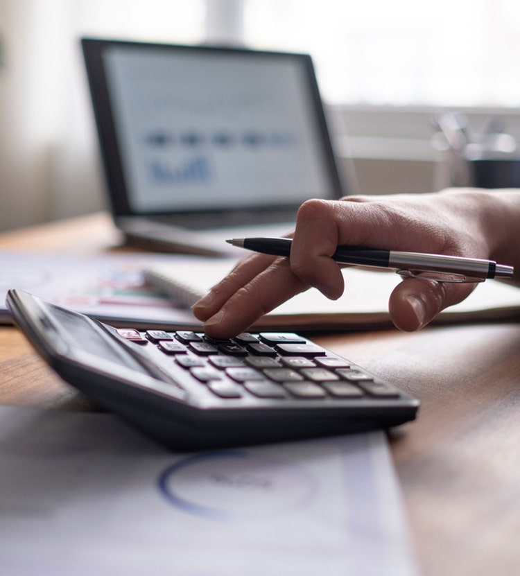 Using a physical desk calculator to conduct a calculation