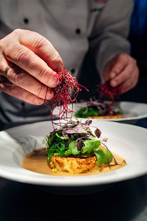 Chef garnishing a dish