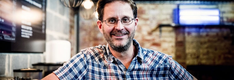 Smiling man in plaid shirt