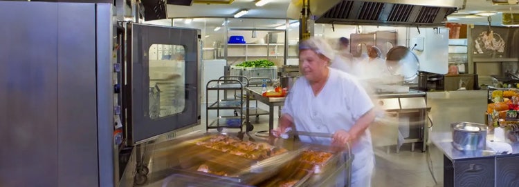Catering team member with a food trolley