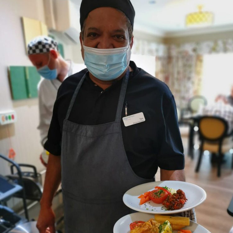 A caterer serving food