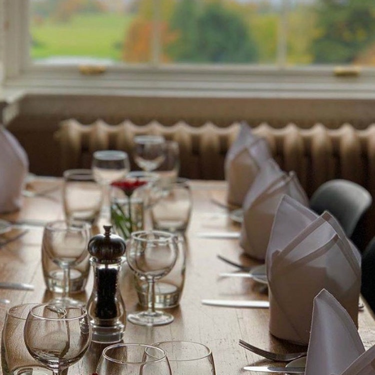 Empty glasses and napkins on a long dining table