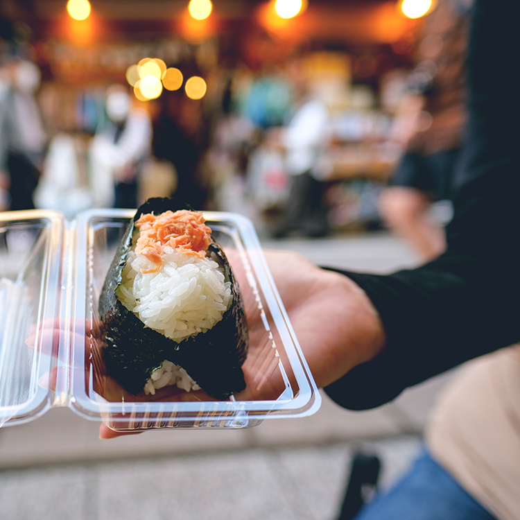 Packaged rice and seaweed snack served in a takeaway container for convenient grab-and-go dining