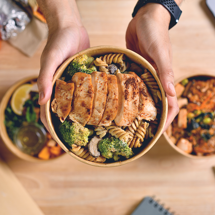 Healthy grab-and-go meal bowl with grilled chicken, pasta, broccoli and mushrooms