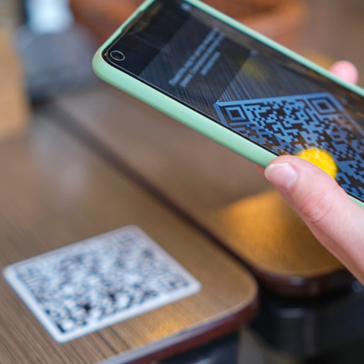 A person scanning a QR code with a smartphone