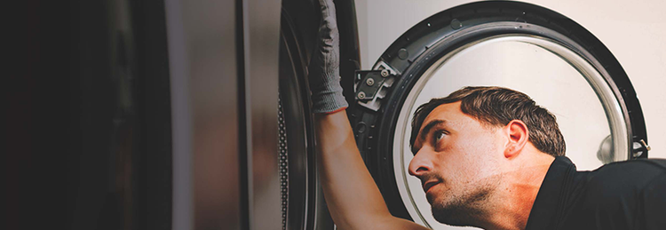 Engineer fixing industrial washing machine