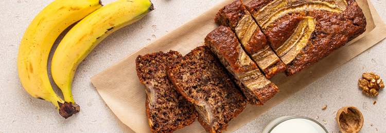 bana bread with banas and nuts beside it