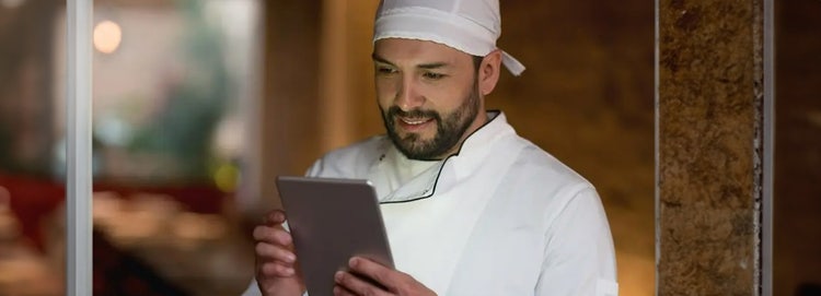 Chef looking at a tablet in his hands
