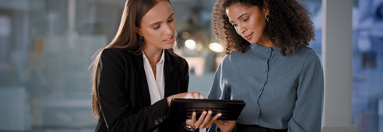 Two women looking at a tablet