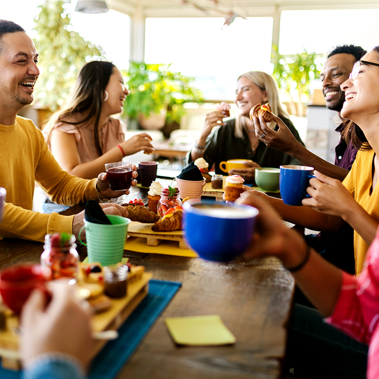 Students dining together in a bright workplace or university café, showcasing collaborative foodservice and catering
