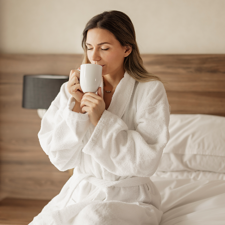 Hotel guest enjoying a hot drink in her room as part of a relaxing stay