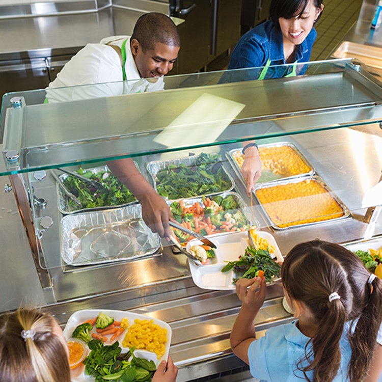 Caterers serving pupils in a school canteen