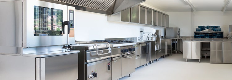 A spacious and clean commercial kitchen featuring modern stainless steel appliances and ample workspace for food preparation.
