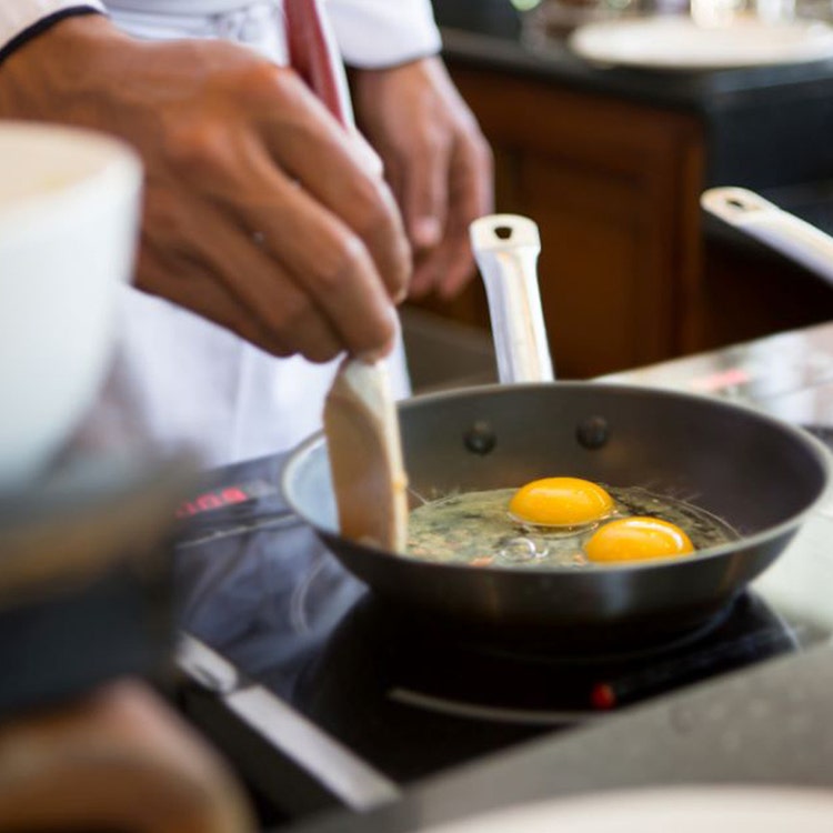 Chef frying eggs