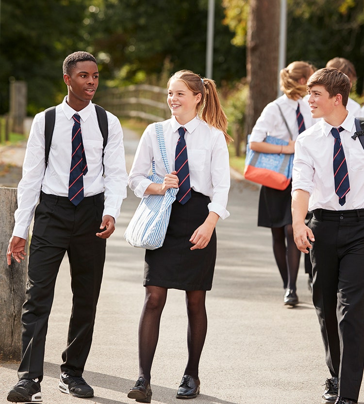 Group of students walking, while dressed in school uniforms
