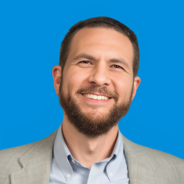 A professional headshot of Hamzah Abu-Ragheb with a blue background