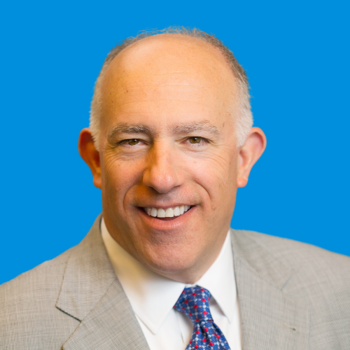 A professional headshot of Walt Sheffler with a blue background