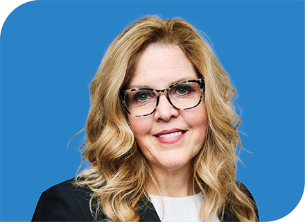 A professional headshot of Eileen Herzog with a blue background