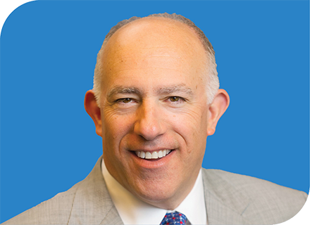 A professional headshot of Walt Sheffler with a blue background