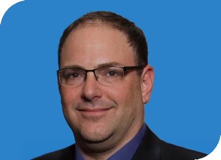 A professional headshot of Jesse Messitte with a blue background