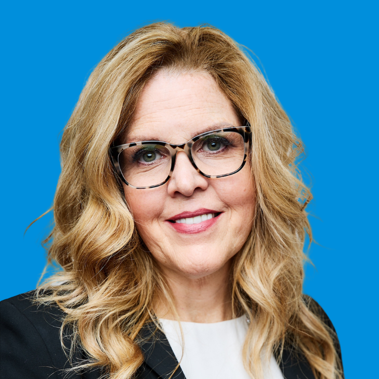 A professional headshot of Eileen Herzog with a blue background