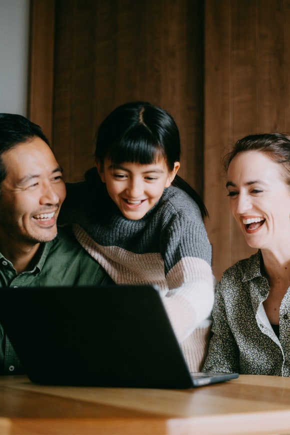 Happy family on a video call with a laptop at Avendra International, work-life balance and employee well-being
