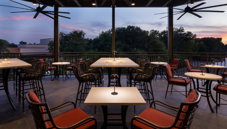 Outdoor restaurant patio with neatly arranged tables and chairs for dining.