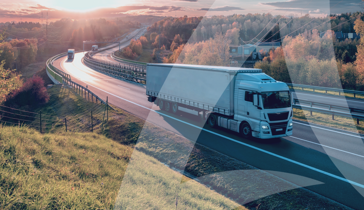 Avendra International truck driving on a highway surrounded by autumn foliage during sunset.
