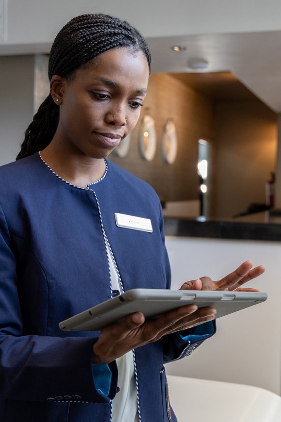 Female hotel manager using a digital tablet at Avendra International, hotel management and technology