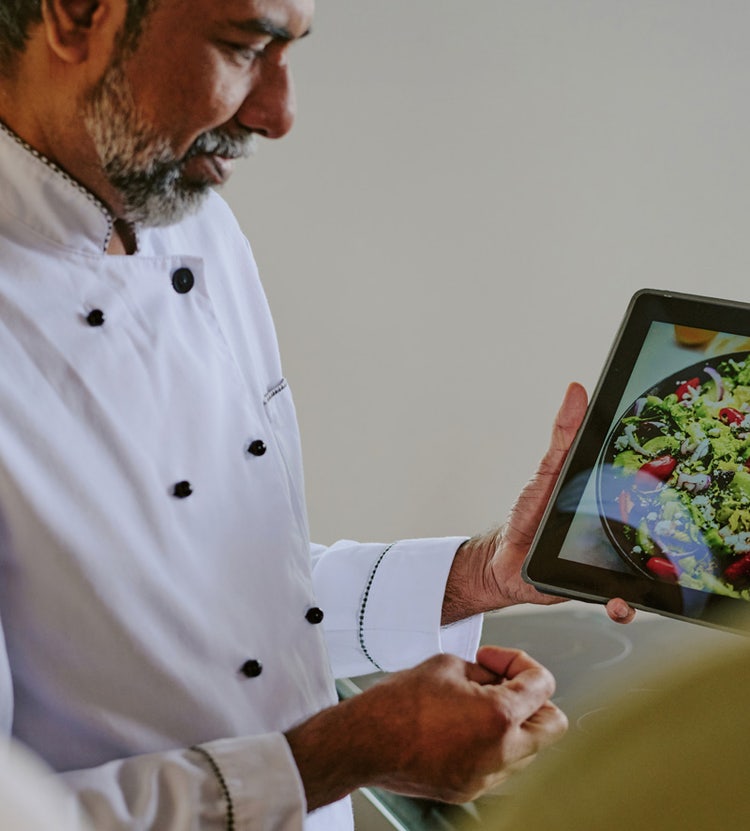 Chef demonstrating a photo of a salad at Avendra International, culinary presentation and menu development