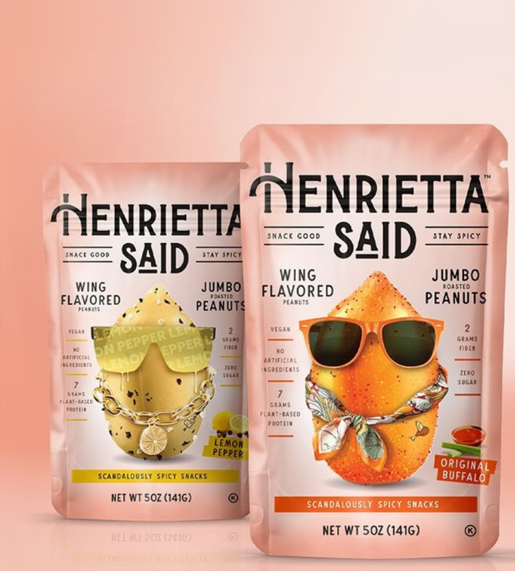 Two packages of Henrietta Said wing-flavored roasted peanuts—Lemon Pepper and Original Buffalo, both vegan and high-protein.
