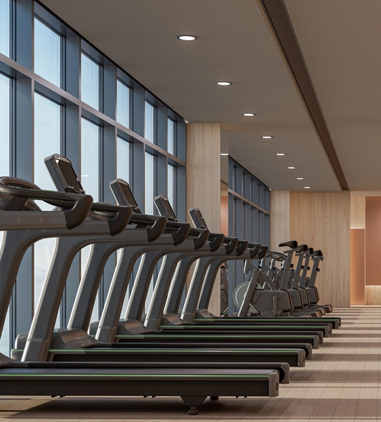 Side view of treadmills at a modern gym managed by Avendra International, hospitality supplies