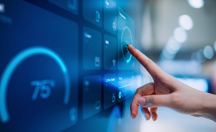 Close-up of woman's hand setting up intelligent home technology at Avendra International, smart home solutions