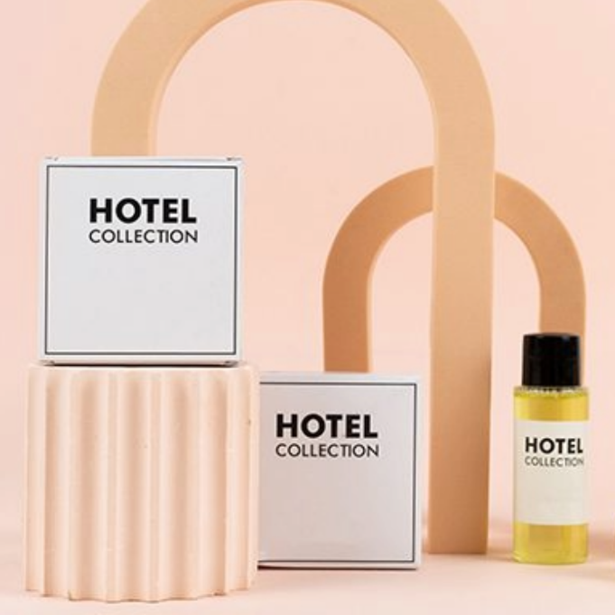 Travel sized bottle labeled Hotel Collection on light peach background