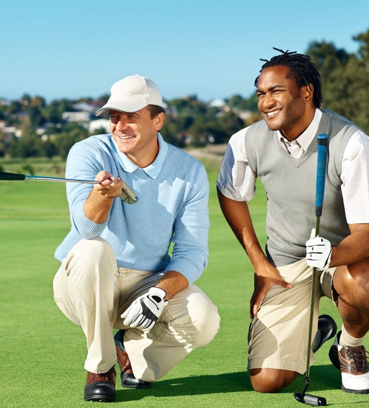 Professional golfers discussing game plan - Avendra International's expert golf services