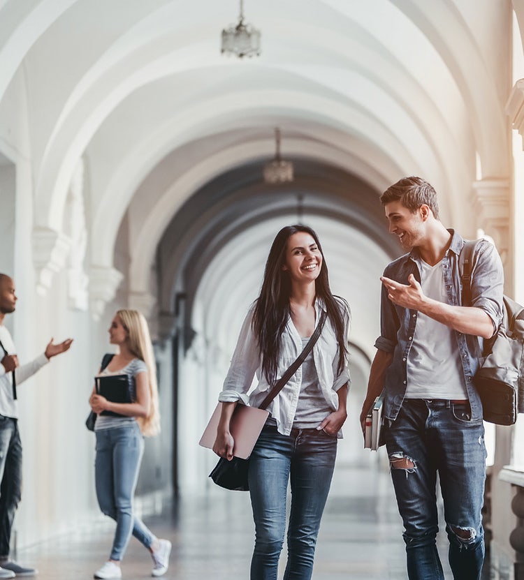 Students walking through a university campus, showcasing Avendra International's procurement solutions for colleges and universities.