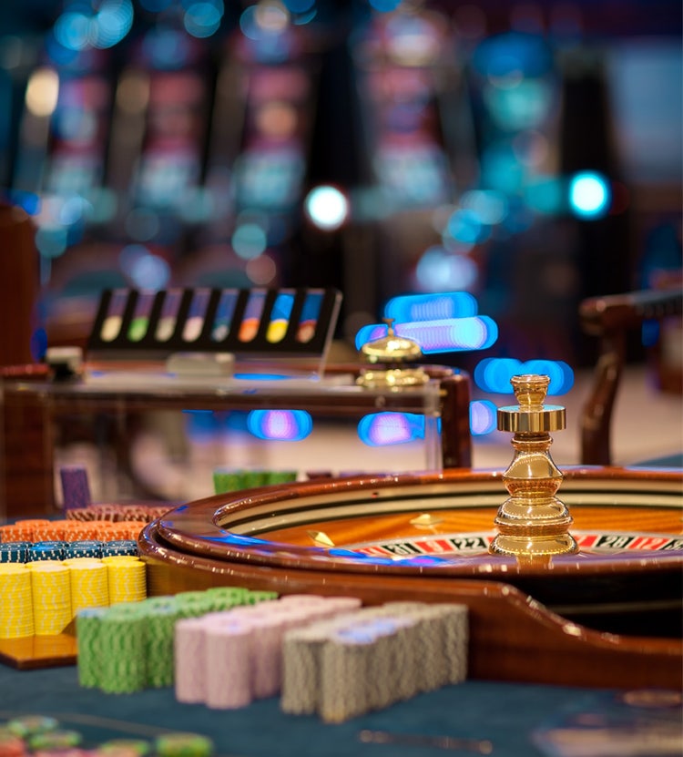 Roulette wheel table with chips piles - Avendra International's top-tier casino and entertainment solutions