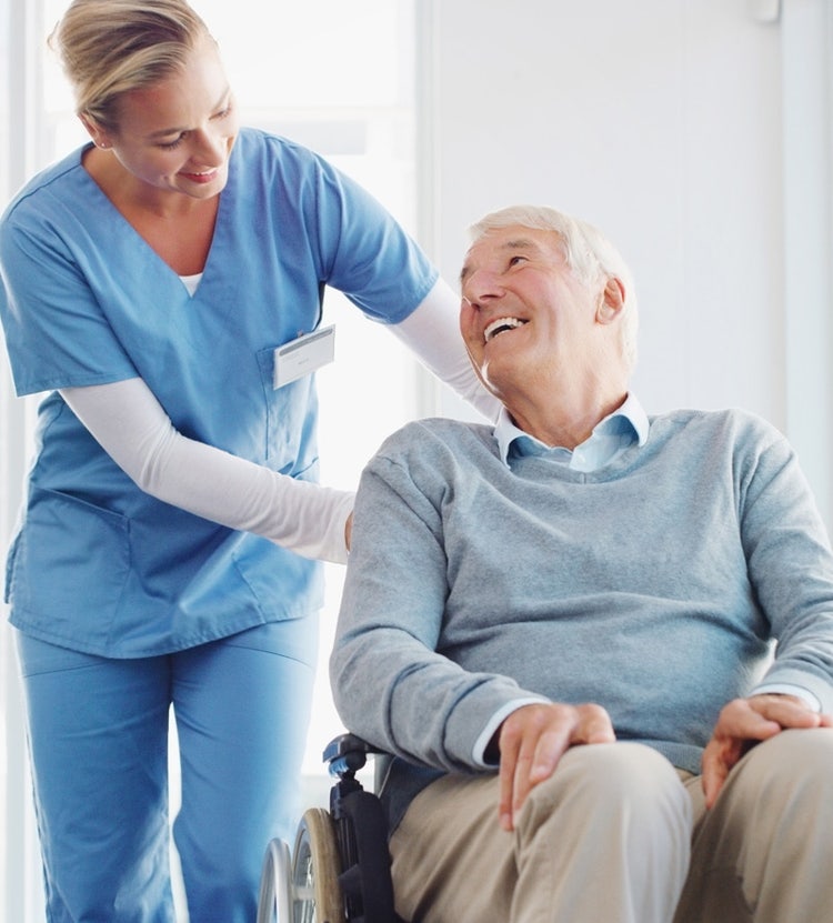 Caregiver assisting an elderly person in a care home, highlighting Avendra International's commitment to quality care and procurement solutions for senior living facilities.
