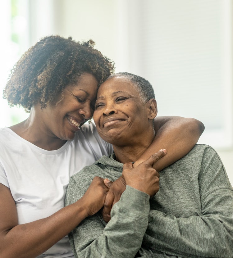 Mother and daughter embracing in a senior living facility, showcasing Avendra International's dedication to enhancing the quality of life for residents through strategic sourcing solutions.