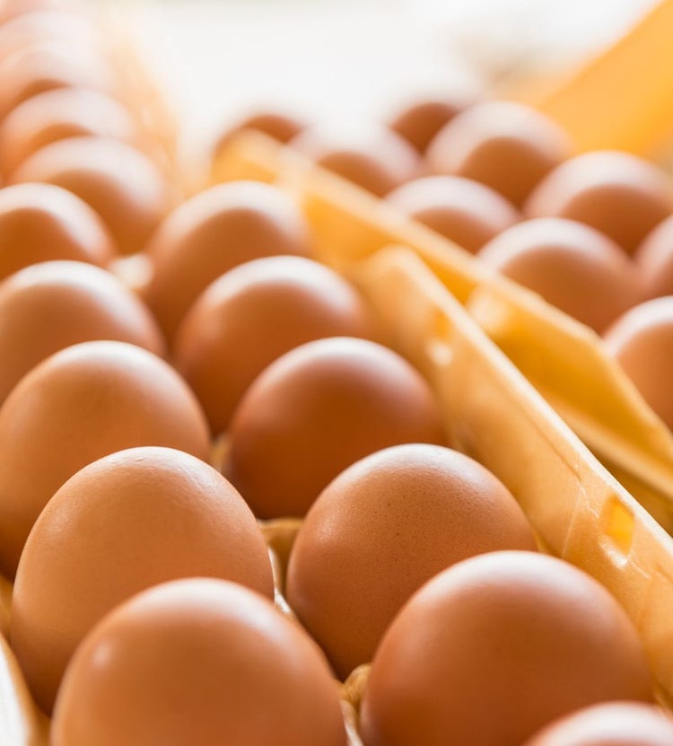 Close-up of cartons of eggs in a commercial kitchen, highlighting Avendra International's reliable supply chain solutions for the food service industry.