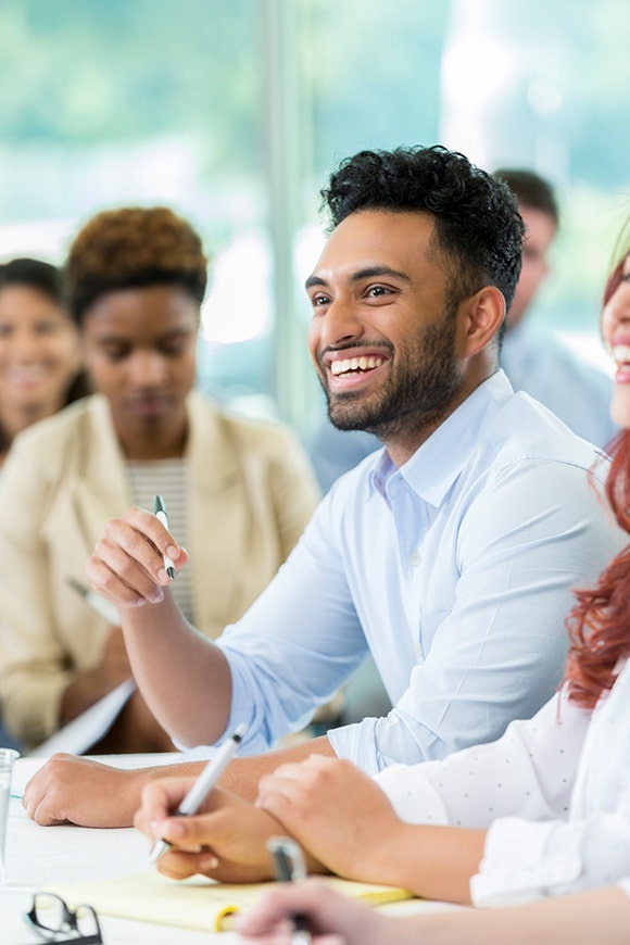 Professionally dressed man taking notes